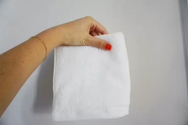 hand holding up Amazon Basics Fast-Drying Absorbent Washcloth