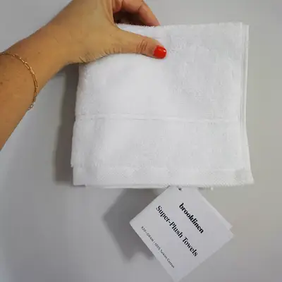 hand holding up Brooklinen Super-Plush Washcloth