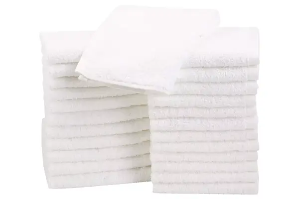 hand holding up Resorè Face Towel in packaging