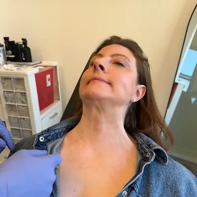Woman in a dermatologist office about to receive neck botox 