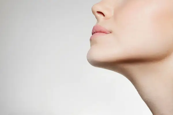Up close photo of person with nose tilted upwards. 