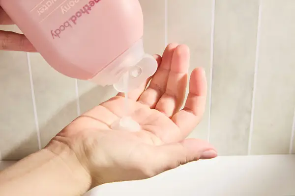 Person dispenses Method Pure Peace Body Wash into their hand
