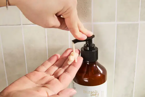 Person dispenses Buttah Egyptian Coco Shea Body Wash into their hand