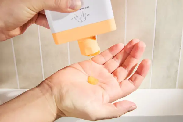 Person dispenses Drunk Elephant Kamili Cream Body Cleanser into their hand