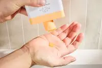 Person dispenses Drunk Elephant Kamili Cream Body Cleanser into their hand