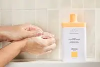 Person tests Drunk Elephant Kamili Cream Body Cleanser on their hands
