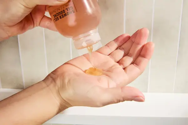 Person dispenses Le Labo Hinoki Shower Gel into their hand