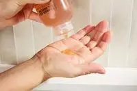 Person dispenses Le Labo Hinoki Shower Gel into their hand