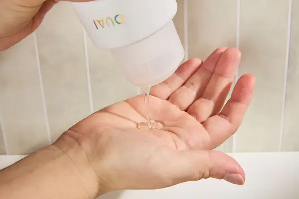 Person dispenses OUAI St. Barts Gentle Body Wash into their hand
