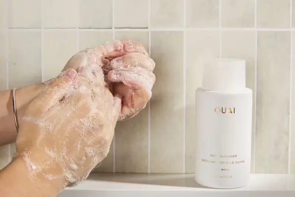 Person tests OUAI St. Barts Gentle Body Wash on their hands