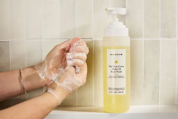 Person tests Naturium The Glow Getter Multi-Oil Hydrating Body Wash on their hands