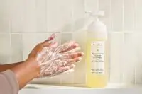 Person tests Naturium The Glow Getter Multi-Oil Hydrating Body Wash on their hands