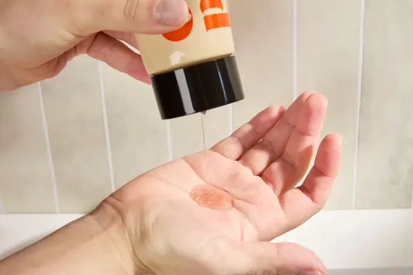 Person dispenses OUI the People Clean Slate Lactic Acid Smoothing Body Wash into their hand