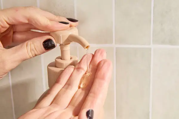 Person dispenses Saltair Bloom Body Wash into their hand