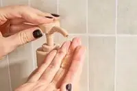 Person dispenses Saltair Bloom Body Wash into their hand