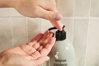 Person dispenses Youth To The People Superfood + Niacinamide Body Cleanser into their hand