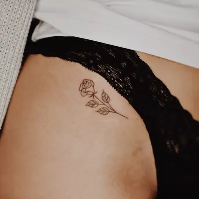 Close up of a pelvic rose tattoo.