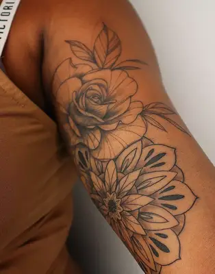 rose tattoo on inside of arm