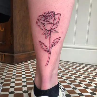 A red and black optical illusion rose tattoo on the back of the ankle.