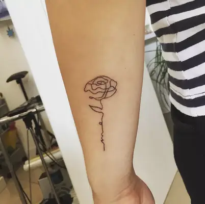single line rose tattoo on back of arm