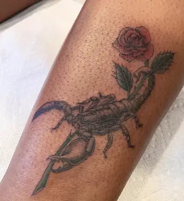 scorpion with rose tattoo on arm