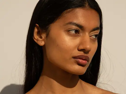 woman with glowing skin in direct sun