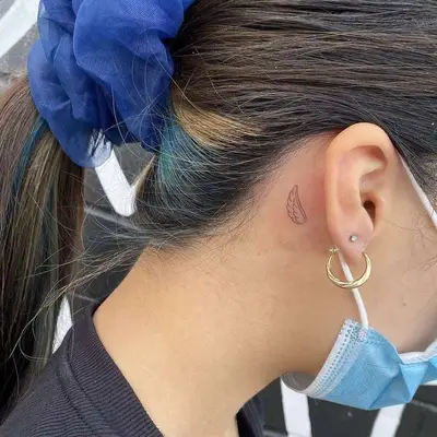 wings behind the ear tattoo