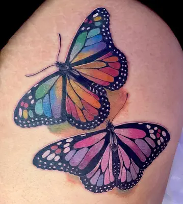 Colorful butterfly tattoos on thigh