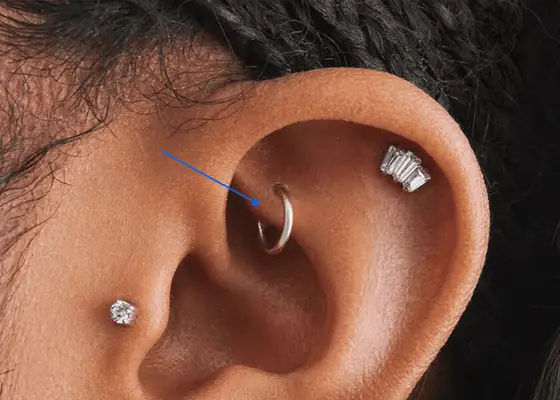 close up of hoop rook piercing in woman