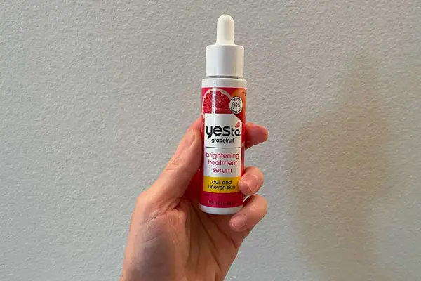 Hand holding Yes To Grapefruit Daily Brightening Serum