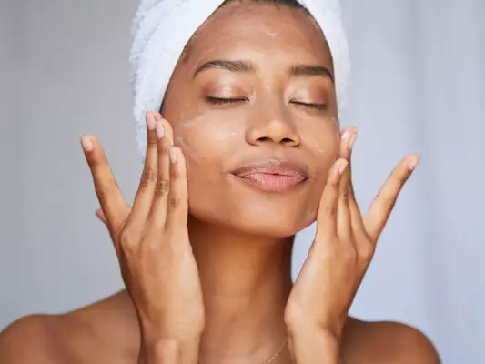 Close up of woman applying skincare to her face