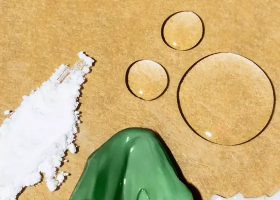 close up of skincare ingredient textures on gold background