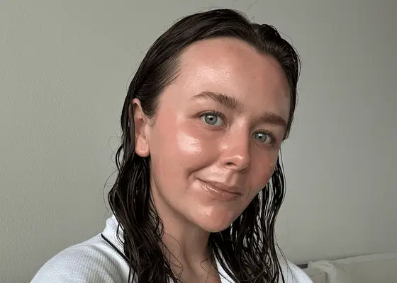 close up of woman with smooth face skin on gray background