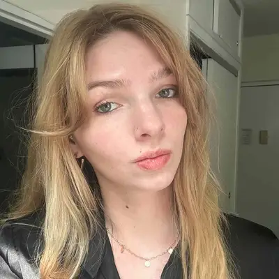 Ali Webb with fresh, radiant skin skin and a gold necklace