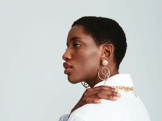 woman with gold earrings