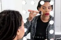 woman applying Mented Cosmetics Skin Silk Loose Setting Powder to face