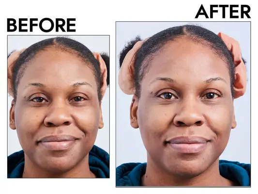 woman smiling in mirror during e.l.f. Cosmetics Halo Glow Setting Powder test