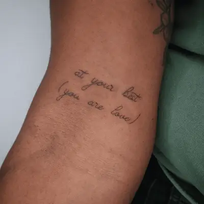 Upper arm text tattoo