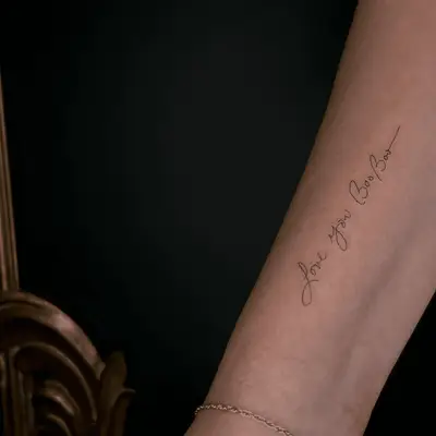Inner arm script tattoo