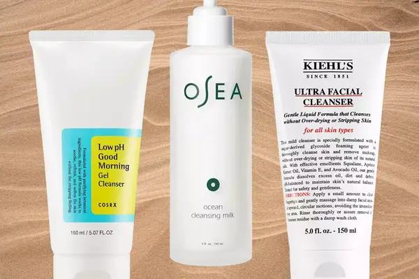 Three face washes for dry skin on a sandy background, including Osea Ocean Cleansing Milk and Kiehl