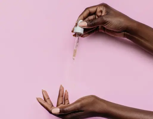 hands with skincare dropper