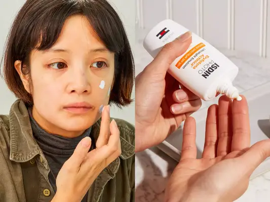 A person dabbing their face with mineral sunscreen next to a hand dispensing Isdin Eryfotona Actinica Mineral SPF 50+ Sunscreen onto other hand with nearby tray and marble countertop
