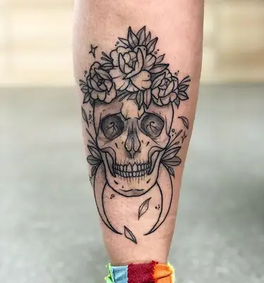 skull tattoo with flowers and crescent moon