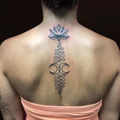 interlocking crescent moon tattoo with lotus flower