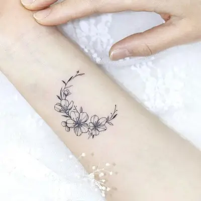flower moon wrist tattoo