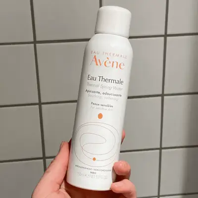 Avène Thermal Spring Water bottle in hand