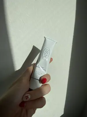 Dieux Skin Instant Angel moisturizer tube in hand