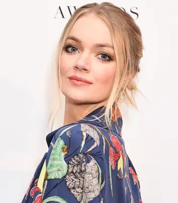 Model with brown smokey eye and peach lipstick