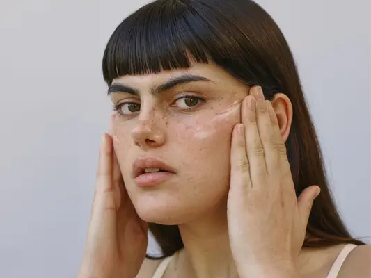 woman applying skin cream