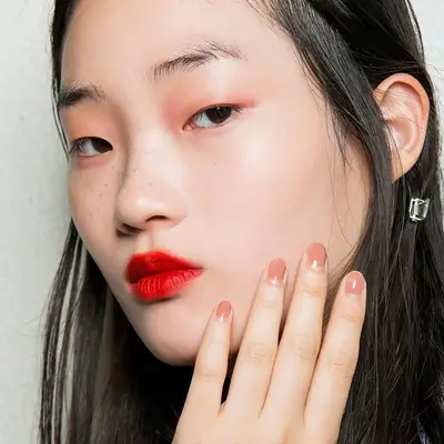 woman with clear skin and red lipstick